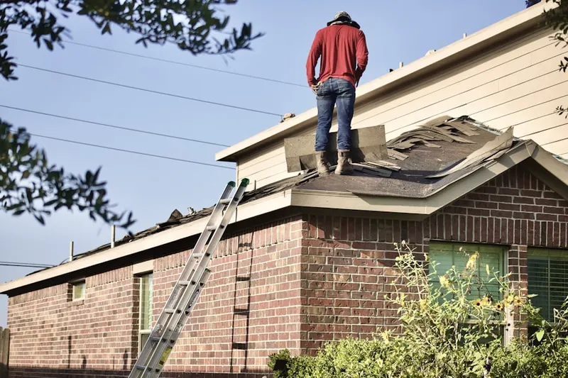 Professional roofer working on a residential roof in Reightown